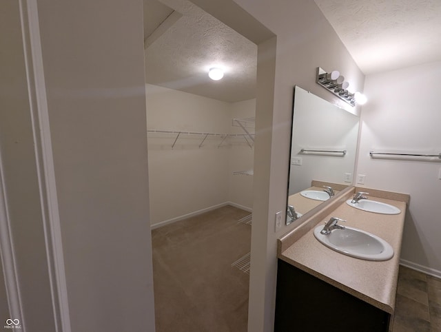 bathroom featuring vanity and a textured ceiling