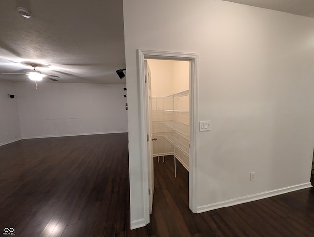 hallway with dark hardwood / wood-style flooring and a textured ceiling