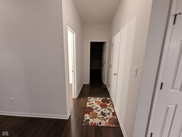 corridor with dark hardwood / wood-style floors