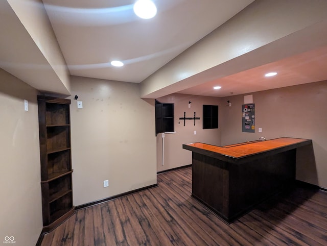 bar featuring dark hardwood / wood-style flooring