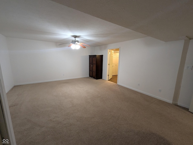 additional living space with light colored carpet and a textured ceiling