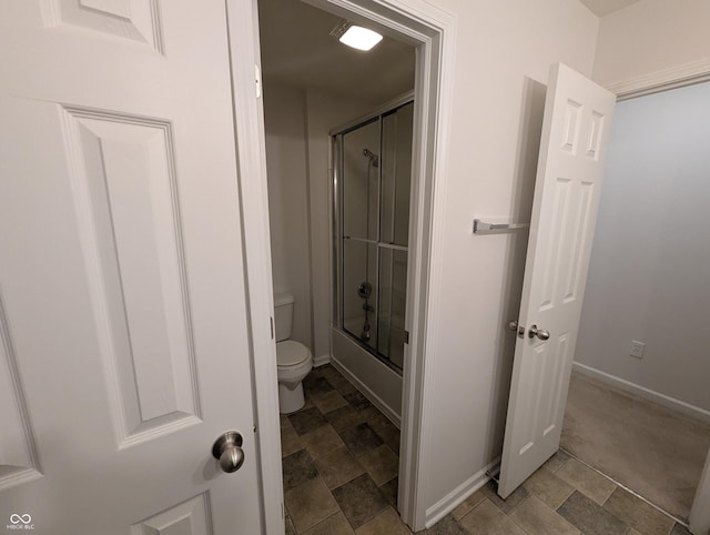 bathroom featuring shower / bath combination with glass door and toilet