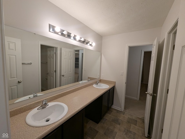 bathroom with vanity and a textured ceiling