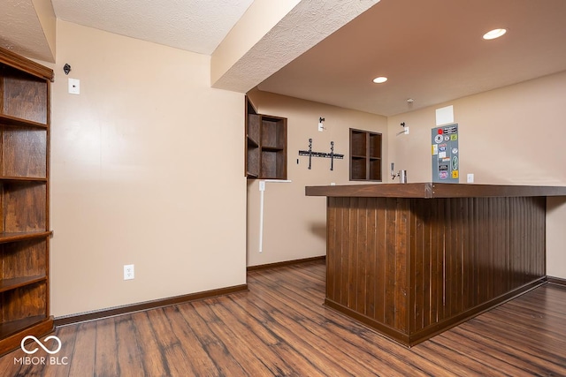 bar with dark wood-style floors, baseboards, indoor wet bar, and recessed lighting