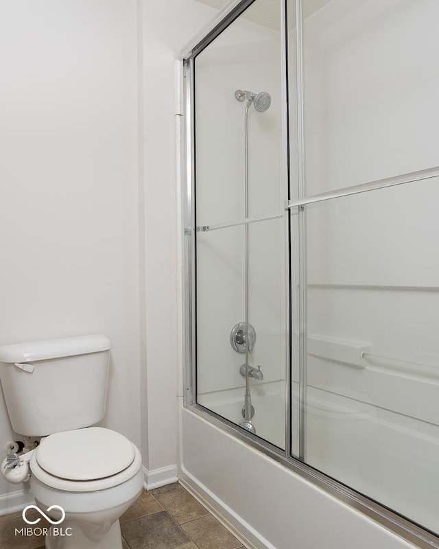 full bath with enclosed tub / shower combo, toilet, and baseboards