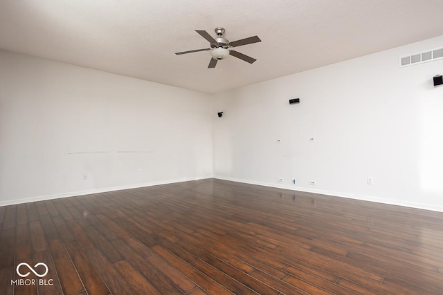 unfurnished room featuring baseboards, visible vents, a ceiling fan, dark wood-style floors, and a textured ceiling