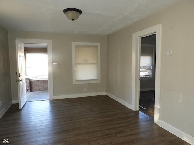 spare room with dark hardwood / wood-style flooring