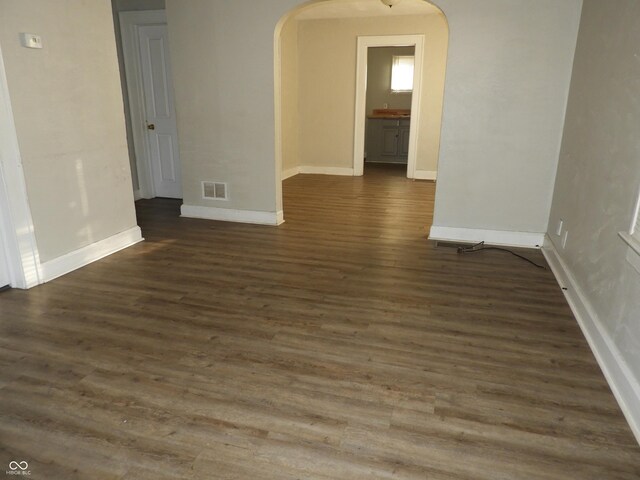 empty room with dark wood-type flooring