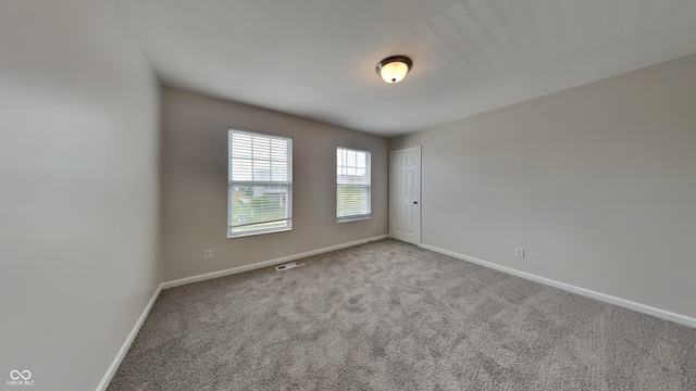 unfurnished room with light colored carpet