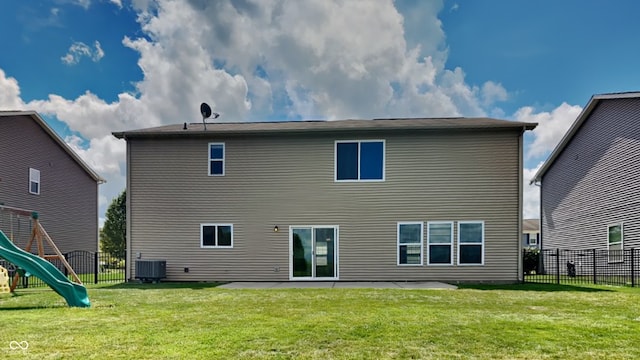 back of house with a playground, a yard, and cooling unit