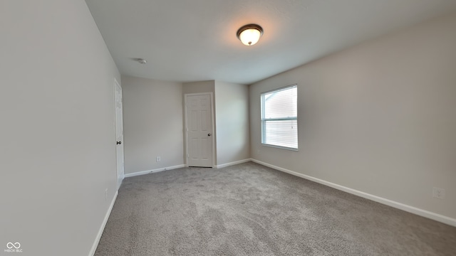 empty room featuring light colored carpet