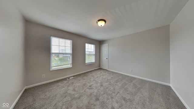 empty room featuring light carpet