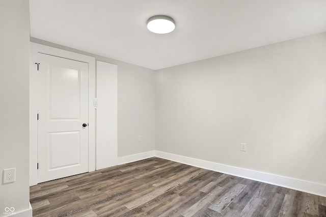 empty room featuring dark wood-type flooring