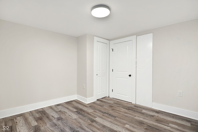 unfurnished bedroom featuring a closet and wood-type flooring