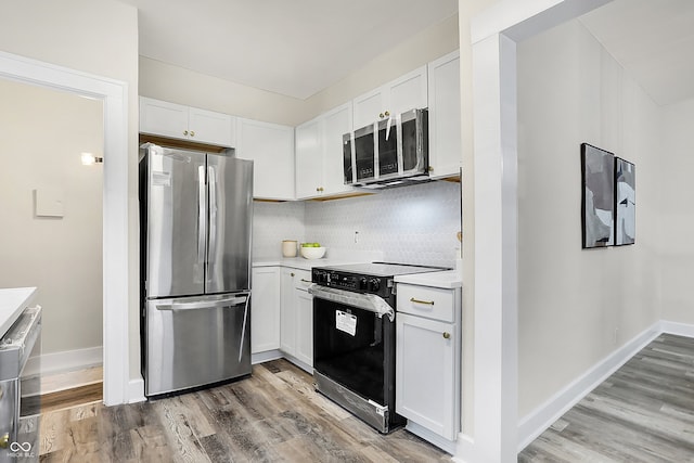 kitchen featuring white cabinetry, stainless steel appliances, and tasteful backsplash