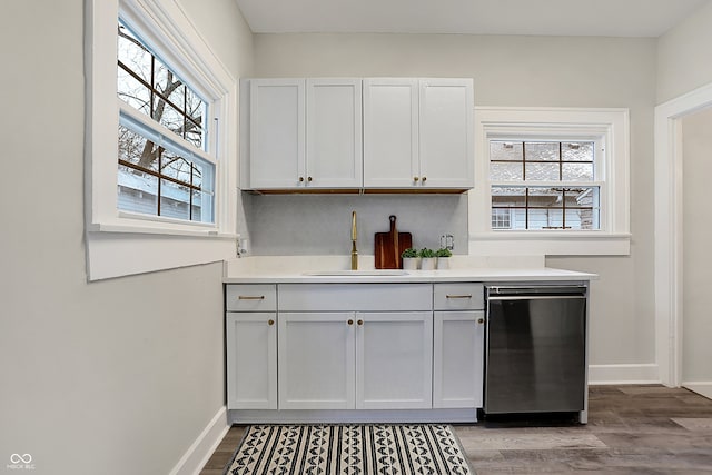 kitchen featuring wood-type flooring, white cabinetry, plenty of natural light, and sink