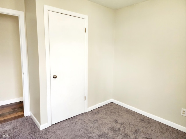 interior space featuring dark carpet