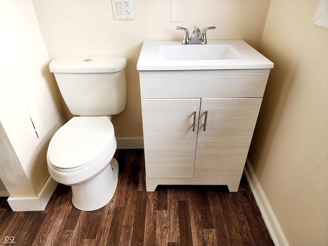 bathroom featuring vanity, wood-type flooring, and toilet