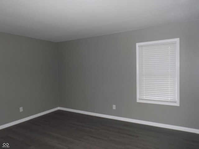 unfurnished room featuring dark hardwood / wood-style flooring