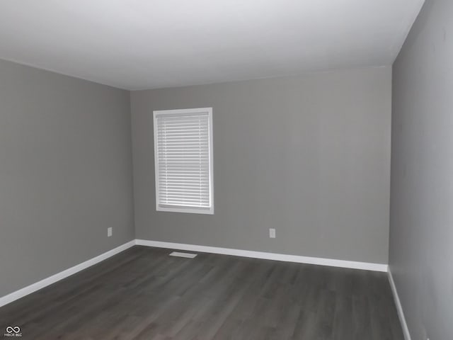 spare room with dark wood-type flooring