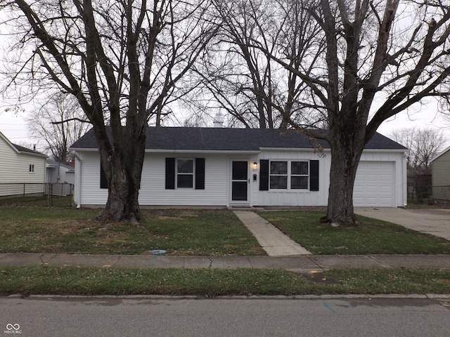 ranch-style home with a garage and a front lawn