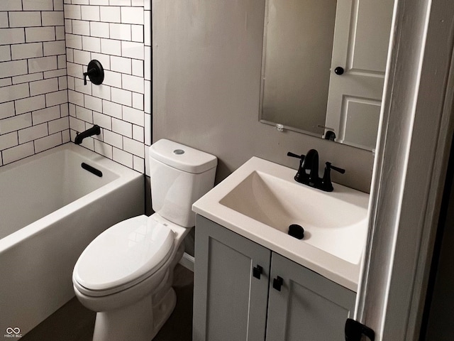 full bathroom featuring tiled shower / bath, vanity, and toilet