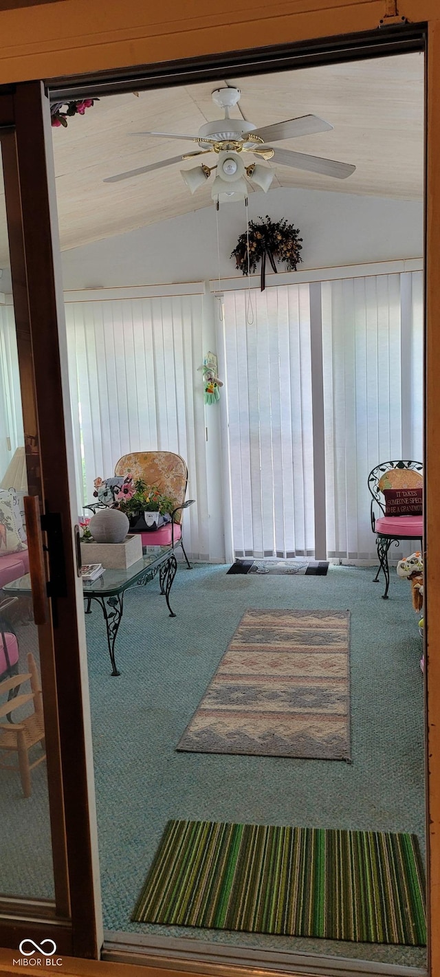 sunroom featuring ceiling fan and vaulted ceiling