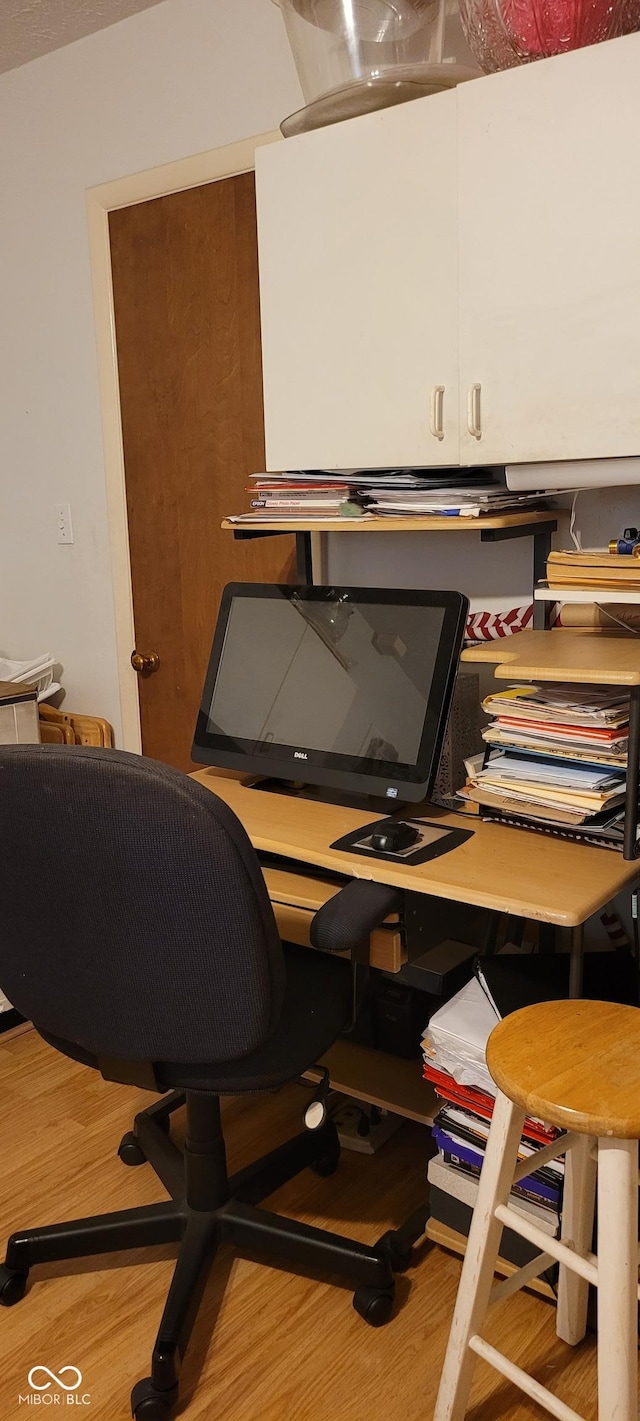 home office with wood-type flooring