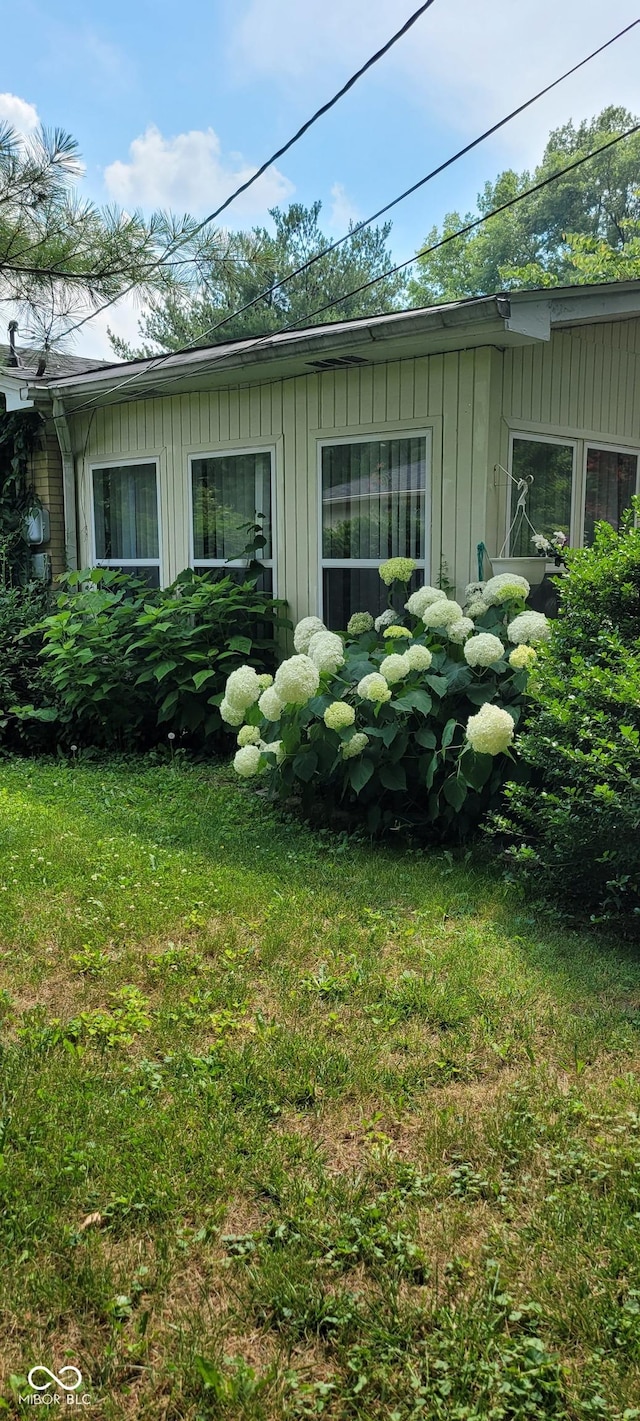 view of property exterior with a yard