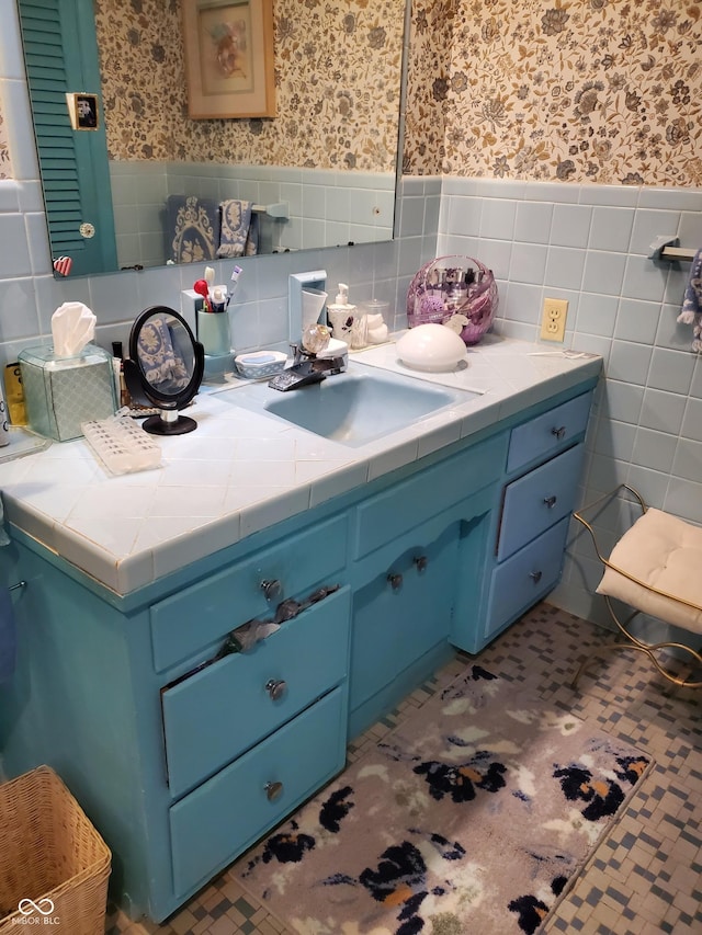 bathroom with tile patterned floors, vanity, and tile walls