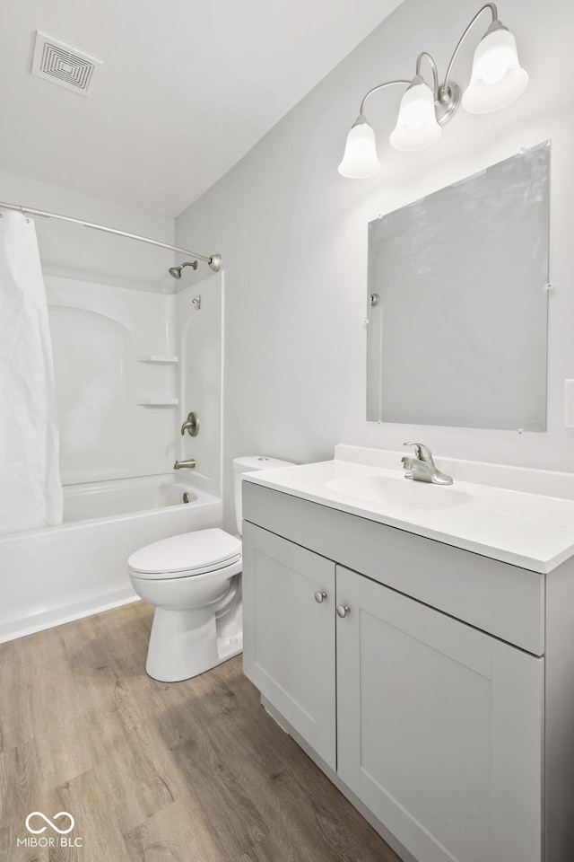 full bathroom with hardwood / wood-style flooring, vanity, toilet, and shower / bathtub combination with curtain