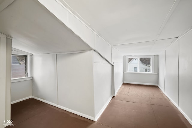 additional living space featuring lofted ceiling