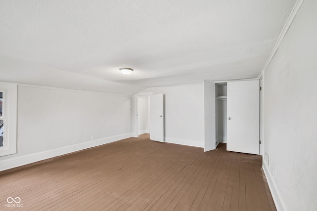 interior space with a closet, dark wood-type flooring, and a textured ceiling