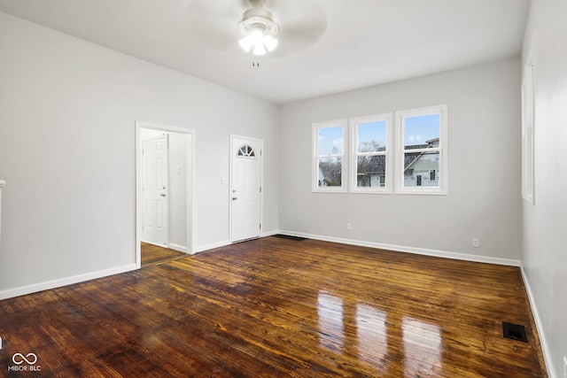 unfurnished room with ceiling fan and dark hardwood / wood-style flooring