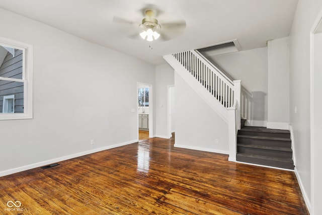 unfurnished living room with ceiling fan and dark hardwood / wood-style flooring