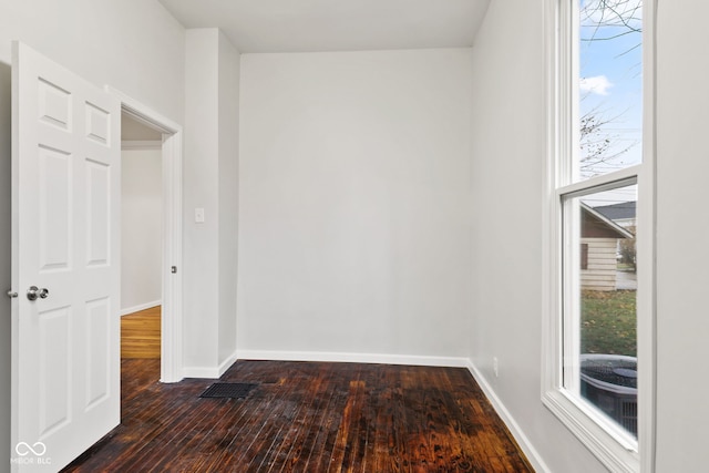 spare room with dark hardwood / wood-style flooring