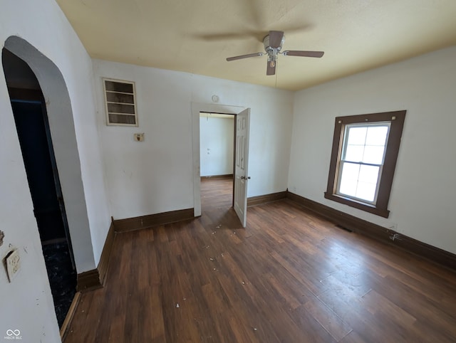 spare room with ceiling fan and dark wood-type flooring