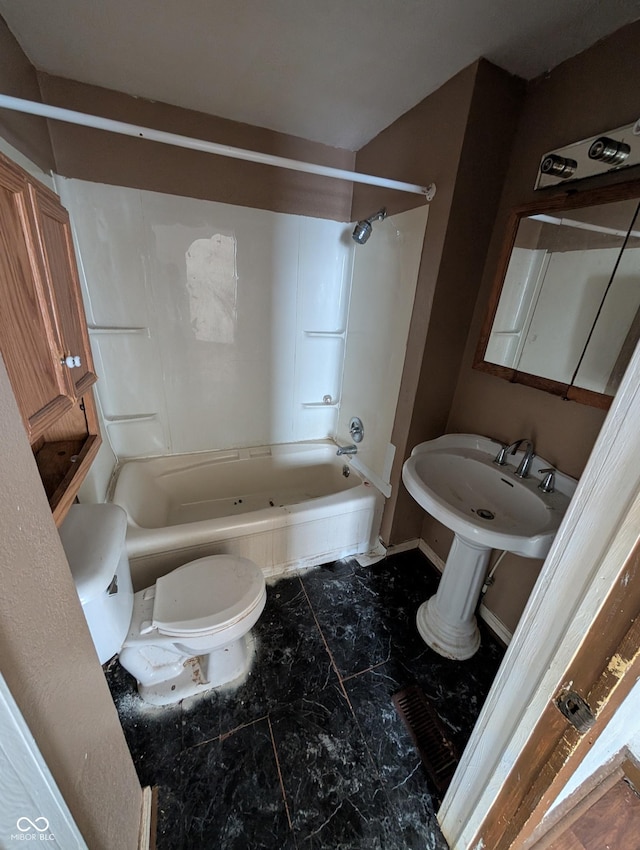 bathroom featuring shower / bathtub combination and toilet