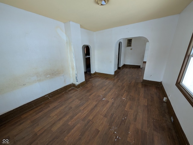 spare room with dark wood-type flooring