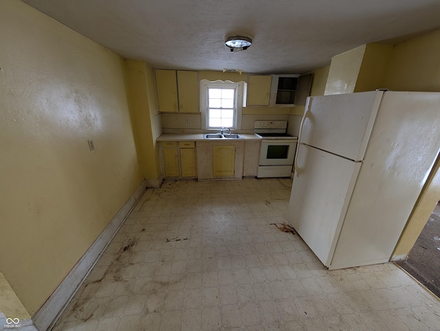 kitchen with a textured ceiling, sink, and white appliances