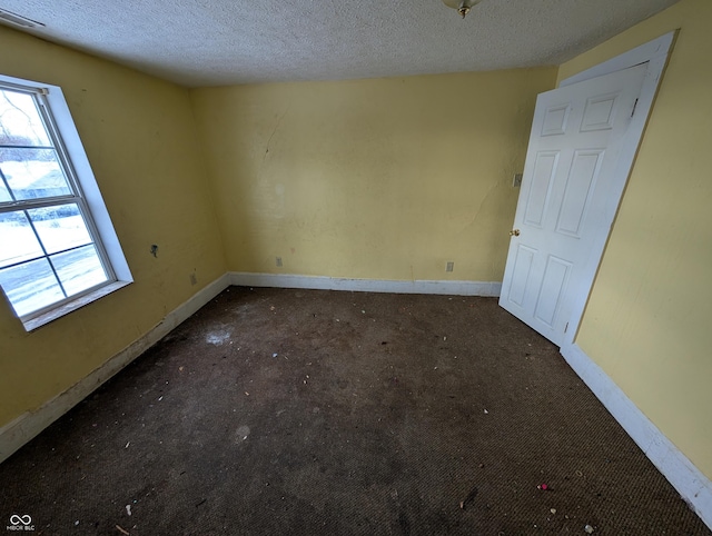 spare room featuring a textured ceiling