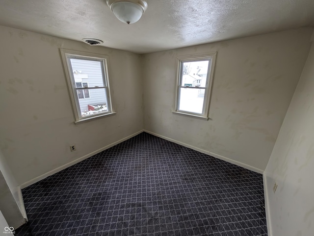 spare room featuring a textured ceiling