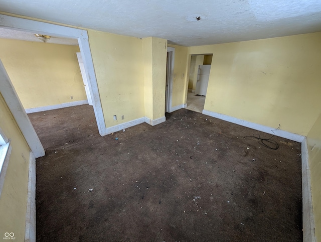 empty room with a textured ceiling