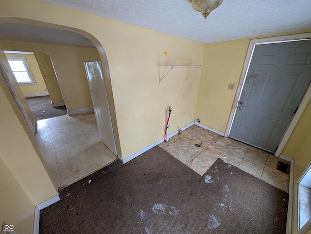 entrance foyer with a textured ceiling