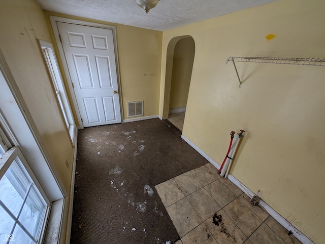 interior space with a textured ceiling