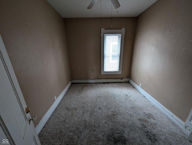 carpeted empty room featuring baseboard heating and ceiling fan