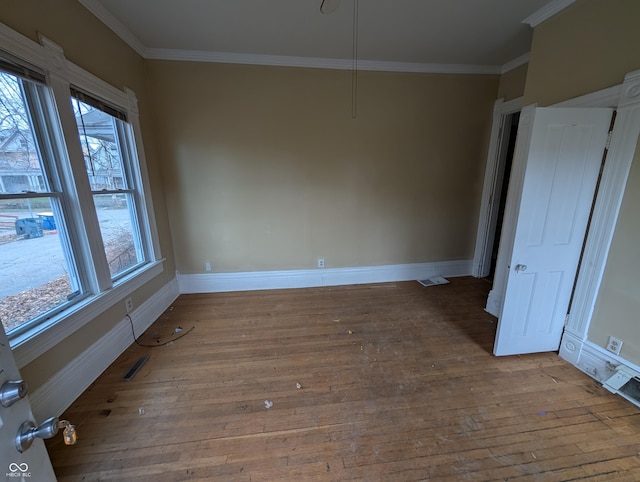 unfurnished dining area with hardwood / wood-style floors, a healthy amount of sunlight, and ornamental molding