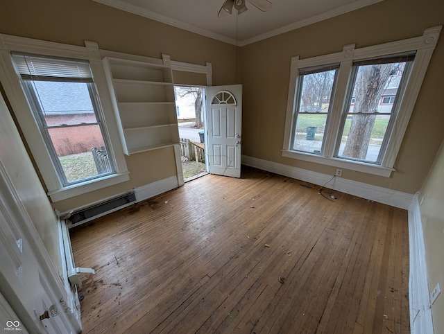 interior space with hardwood / wood-style flooring, ceiling fan, crown molding, and a wealth of natural light