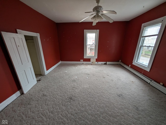 carpeted empty room featuring ceiling fan and a healthy amount of sunlight