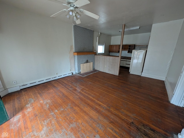 unfurnished living room featuring ceiling fan, dark wood-type flooring, and a baseboard heating unit